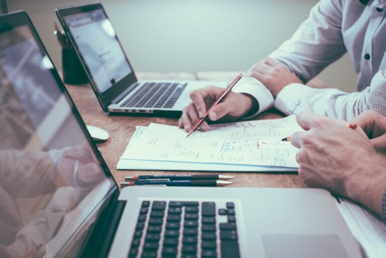 Business owner reviewing financial documents at desk