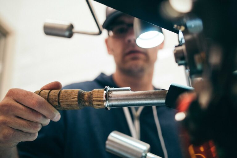 Roofing contractor on roof installing shingles