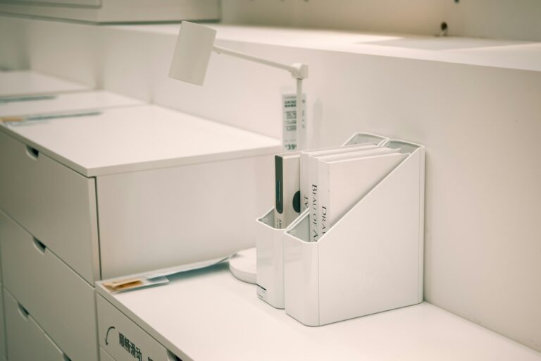 Organized white file organizer with documents on an office desk