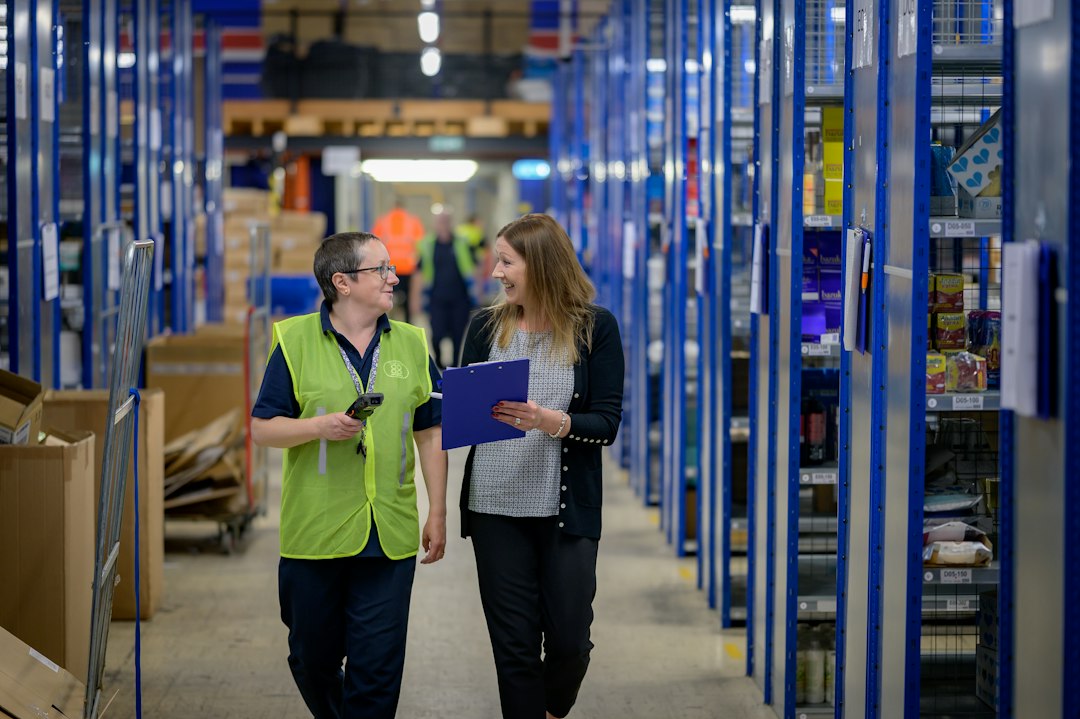 Warehouse operations team reviewing inventory with a clipboard