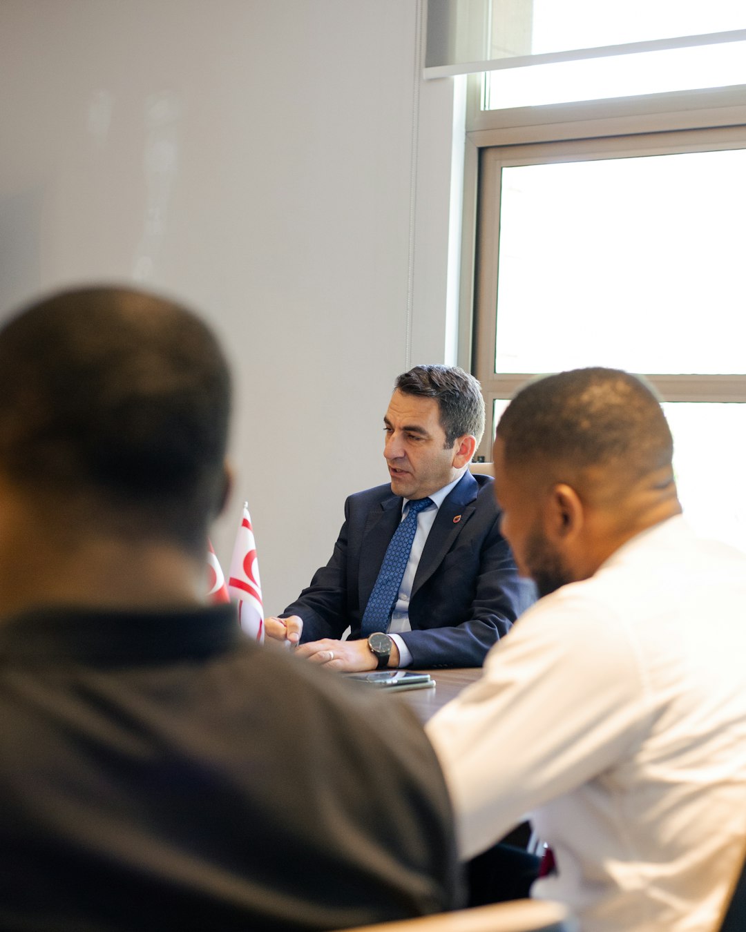 Business leaders meeting in a boardroom to discuss a private equity exit