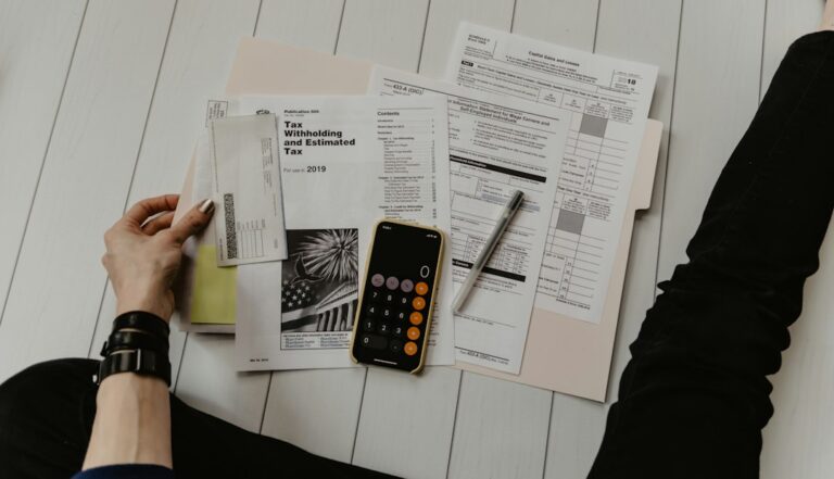 Financial documents and calculator on a desk during a business review
