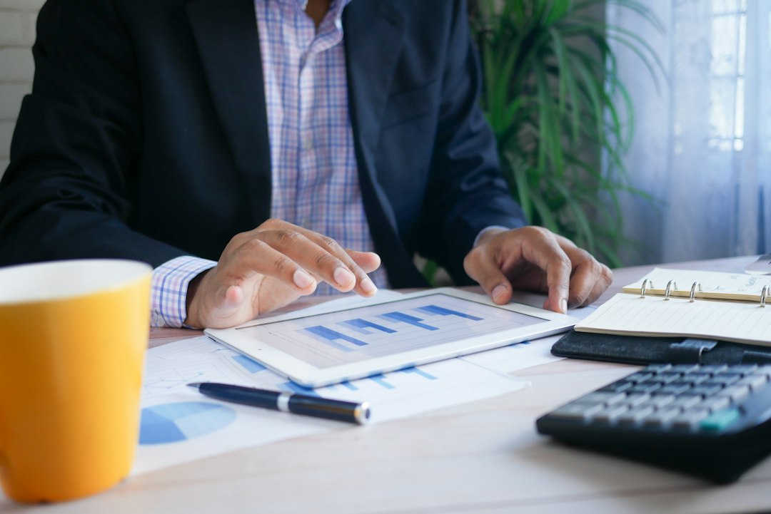 Business professional reviewing loan documents on a tablet