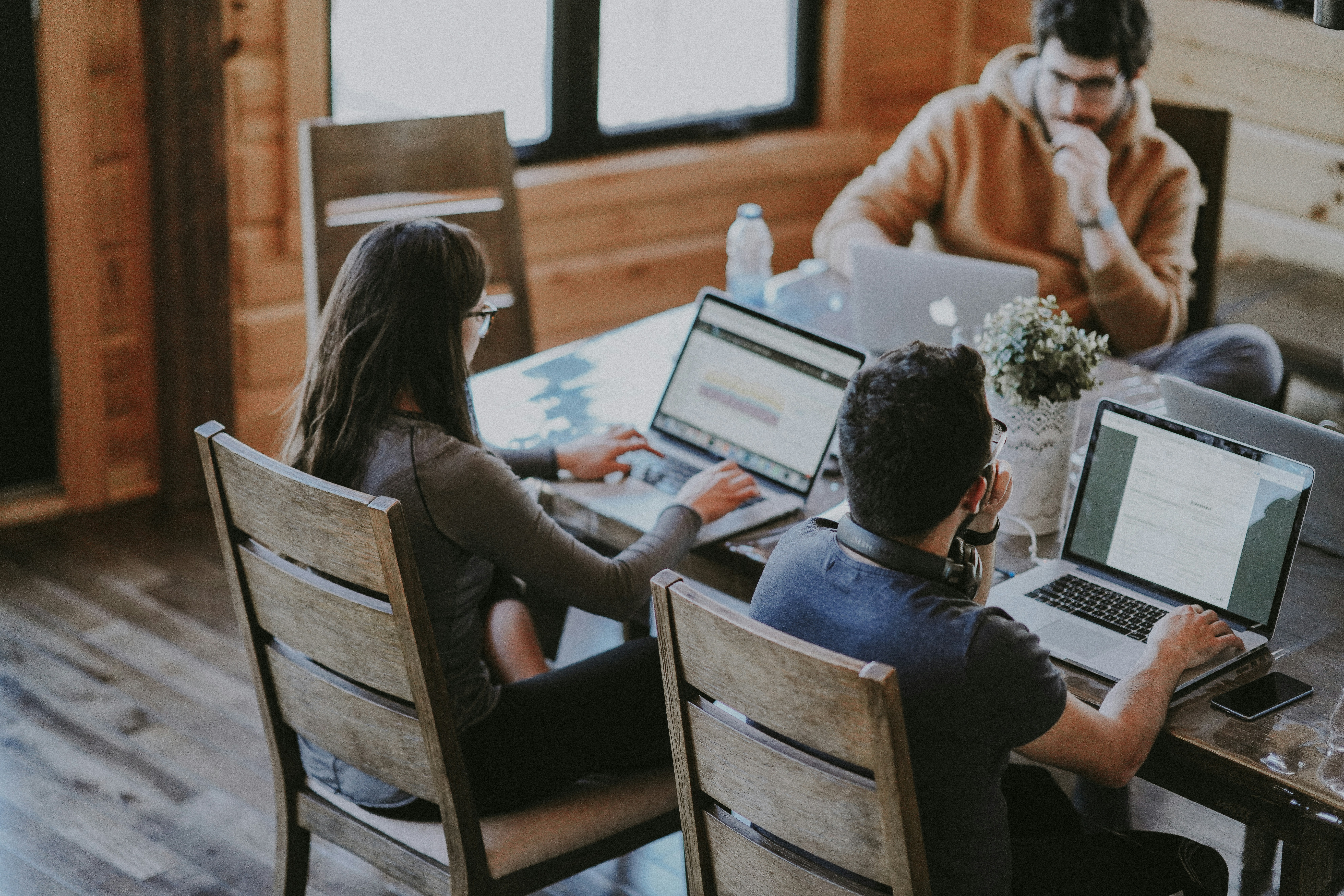 Team collaborating around laptops in a modern office